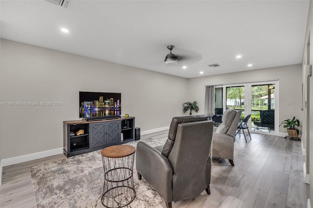 living room with french doors, ceiling fan, and light hardwood / wood-style flooring