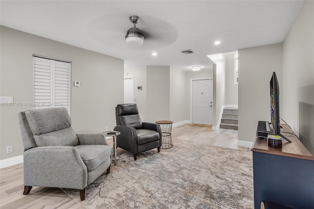 living area featuring ceiling fan and light wood-type flooring