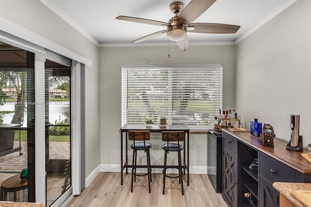 bar with ceiling fan, crown molding, and light hardwood / wood-style flooring