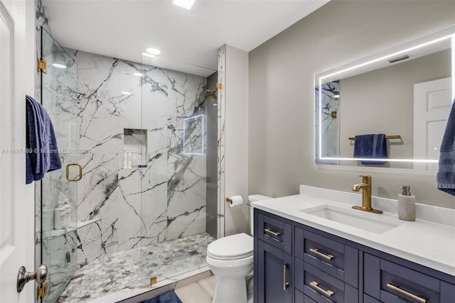 bathroom with toilet, a shower with door, vanity, and tile patterned flooring