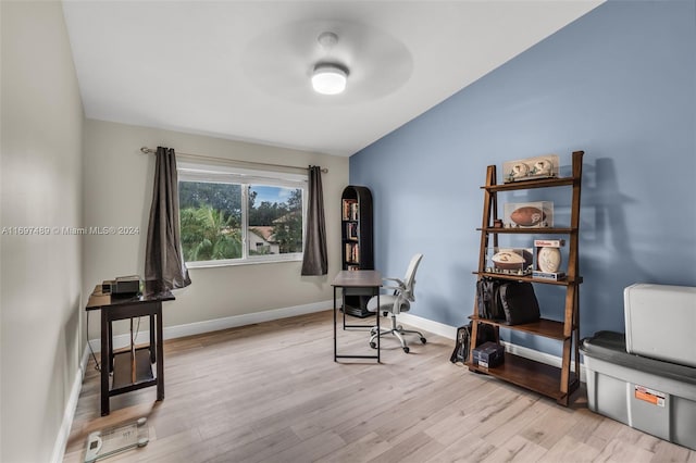 home office featuring ceiling fan and light hardwood / wood-style flooring