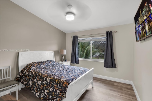 bedroom featuring lofted ceiling and hardwood / wood-style flooring