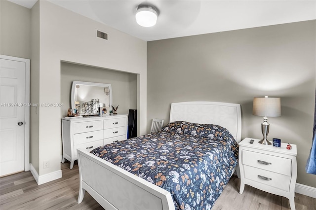 bedroom with ceiling fan and light hardwood / wood-style floors