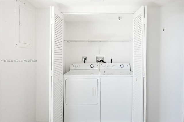 clothes washing area featuring washer and dryer and electric panel