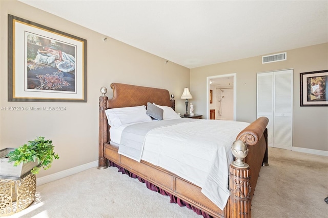 bedroom featuring light colored carpet, connected bathroom, and a closet