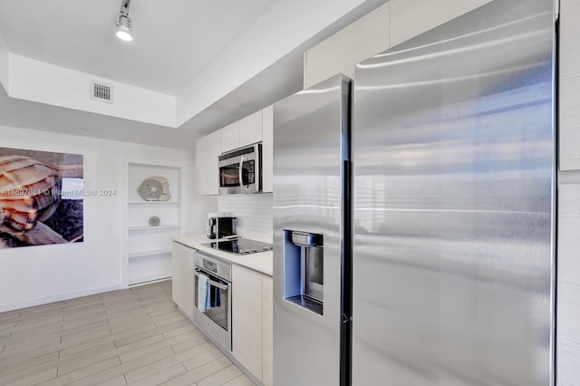 kitchen featuring white cabinets and appliances with stainless steel finishes