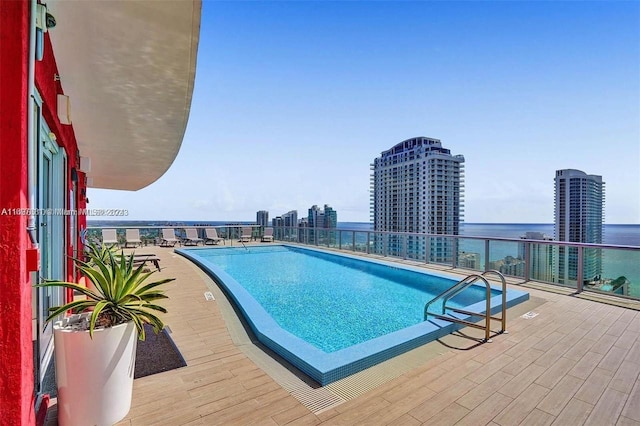 view of swimming pool featuring a water view