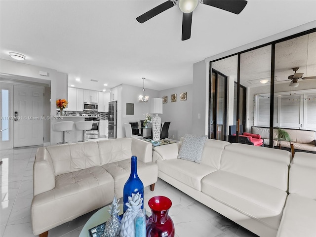 living room with ceiling fan with notable chandelier