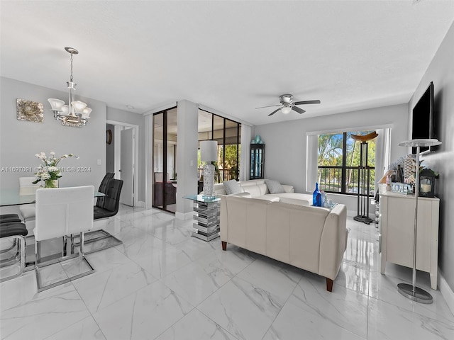 living room featuring ceiling fan with notable chandelier