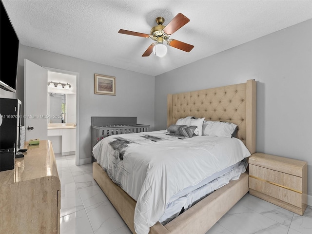 bedroom featuring connected bathroom, a ceiling fan, a textured ceiling, and marble finish floor