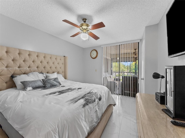 bedroom featuring a ceiling fan, a textured ceiling, access to exterior, and marble finish floor
