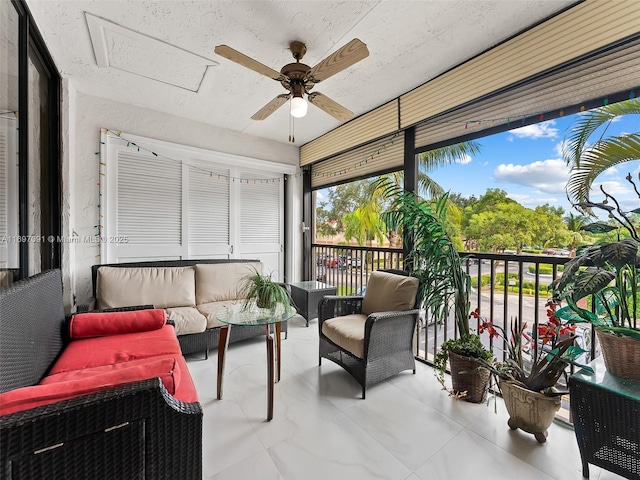 sunroom featuring a ceiling fan and an outdoor hangout area