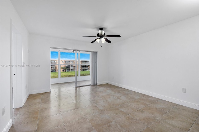 spare room featuring ceiling fan and light tile patterned flooring