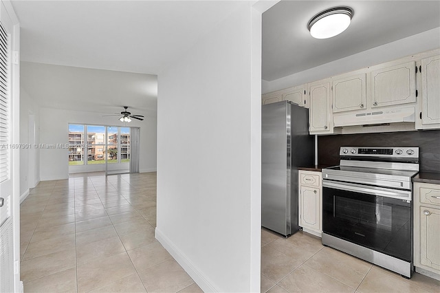 kitchen with decorative backsplash, light tile patterned floors, stainless steel appliances, and ceiling fan