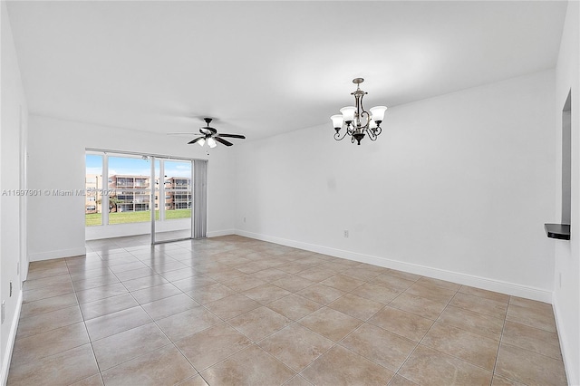 tiled empty room featuring ceiling fan with notable chandelier