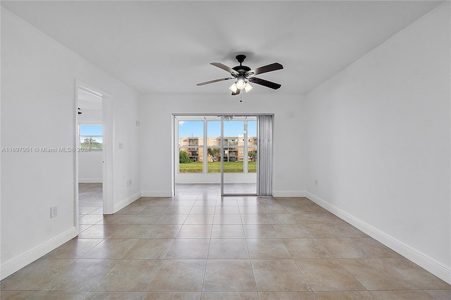 tiled empty room with ceiling fan