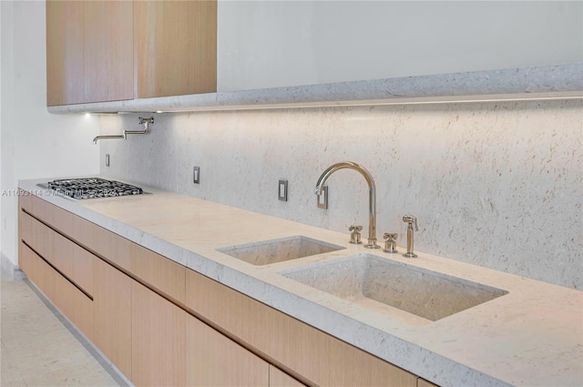 kitchen featuring sink, light brown cabinets, and stainless steel gas stovetop