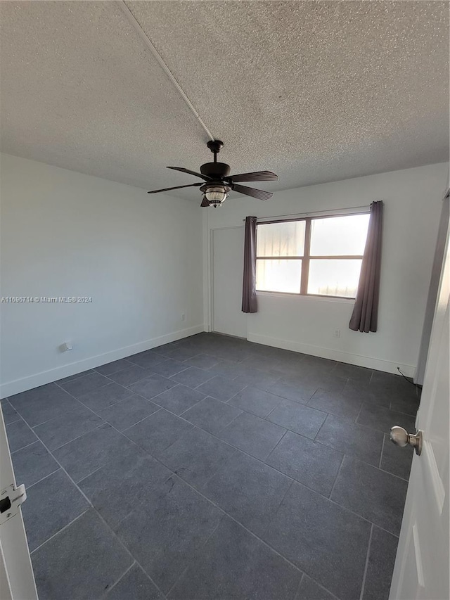 unfurnished room with baseboards, a textured ceiling, and ceiling fan