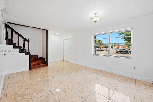 unfurnished room featuring a textured ceiling