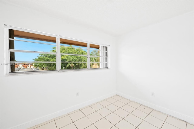 spare room featuring light tile patterned floors