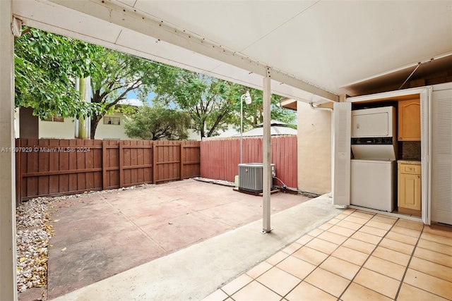 view of patio / terrace featuring central AC unit and stacked washer / drying machine