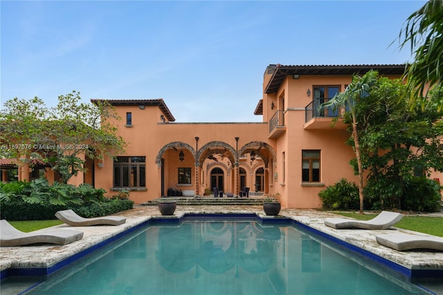 rear view of property with a balcony