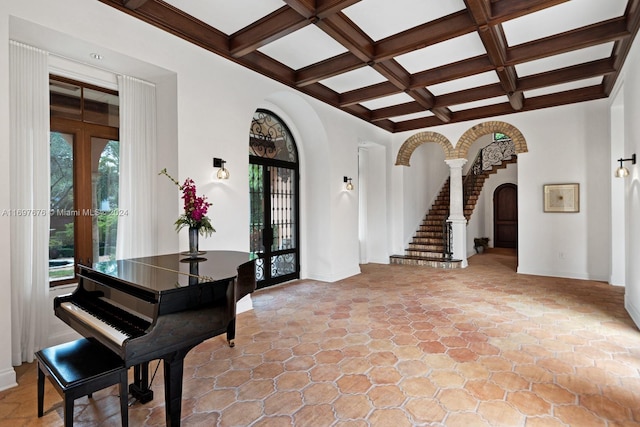 foyer with beamed ceiling, french doors, and coffered ceiling