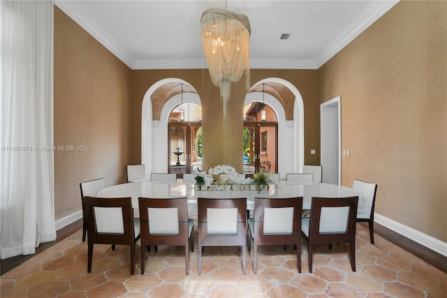 dining area with crown molding and an inviting chandelier