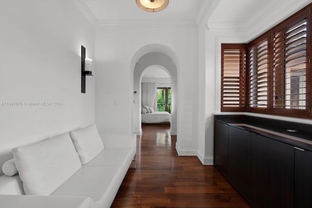 hall featuring ornamental molding and dark wood-type flooring