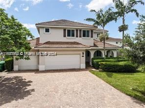 view of front of house featuring a garage and a front lawn