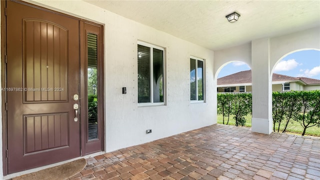 view of exterior entry with a porch