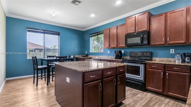 kitchen featuring black appliances, a kitchen island, crown molding, and light hardwood / wood-style flooring