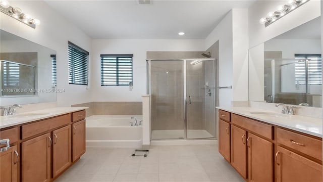 bathroom with tile patterned flooring, vanity, and shower with separate bathtub