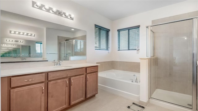 bathroom featuring tile patterned floors, vanity, and shower with separate bathtub