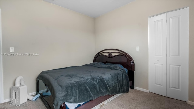 bedroom with light colored carpet and a closet