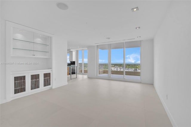 unfurnished living room with a wall of windows