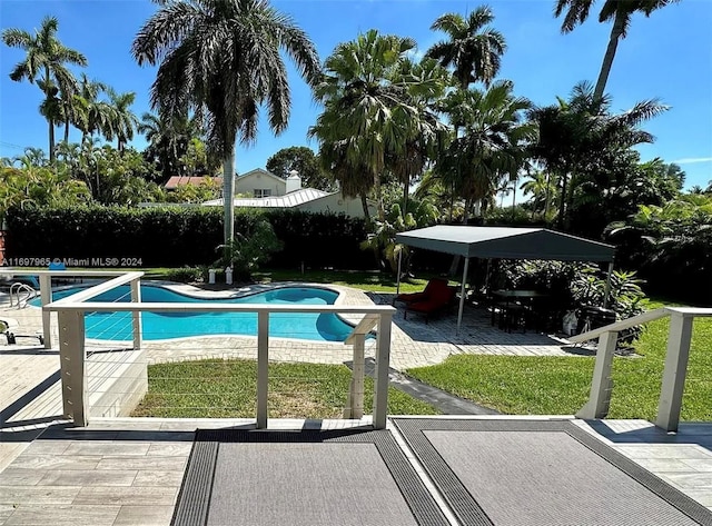 view of pool featuring a patio area and a yard