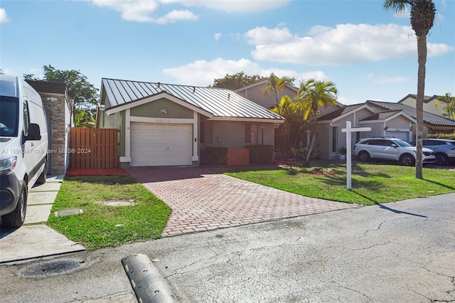 view of front of house with a front yard and a garage