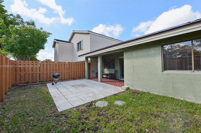 back of house featuring a yard and a patio