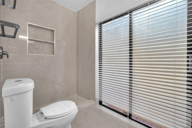 bathroom featuring walk in shower, tile patterned flooring, and toilet