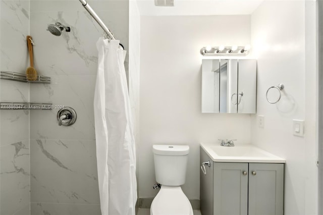 bathroom with curtained shower, vanity, and toilet