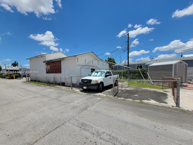 view of property exterior featuring a storage unit