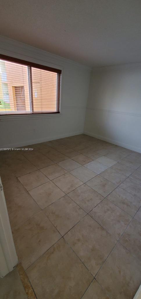 empty room with plenty of natural light and light tile patterned flooring