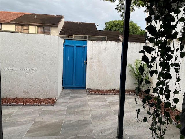 13380 SW 91st Ter Unit E, Miami, FL 33186 - entrance to property with stucco siding and a patio area