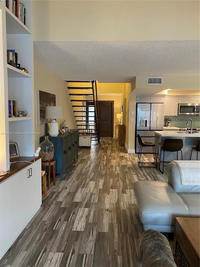 13380 SW 91st Ter Unit E, Miami, FL 33186 - living room with a textured ceiling and dark wood-type flooring