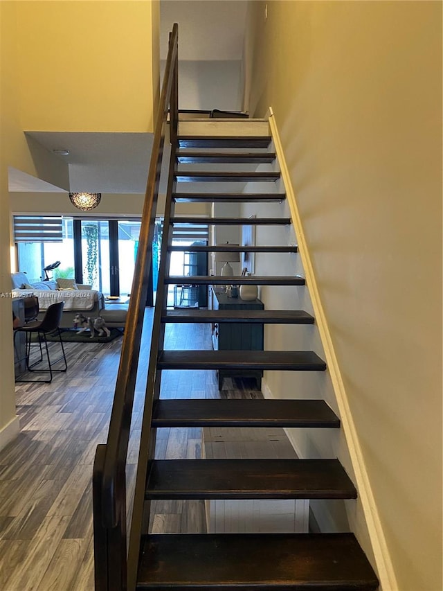 staircase with wood-type flooring