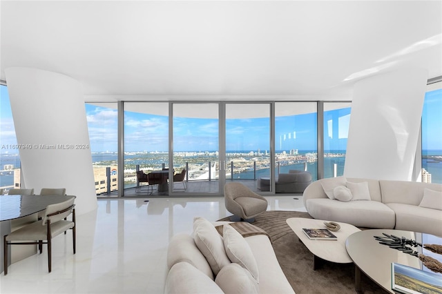 living room featuring a water view and floor to ceiling windows