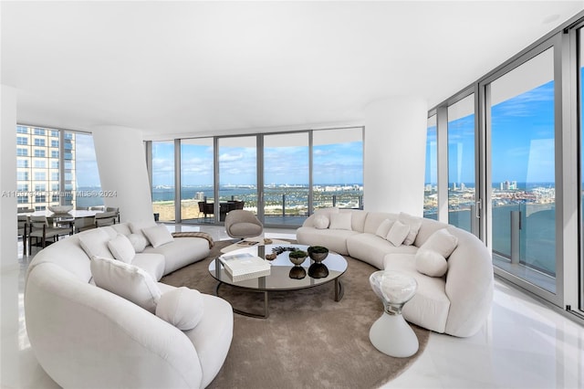 living room with a water view and a wall of windows