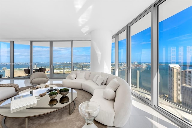 living room with floor to ceiling windows and a water view