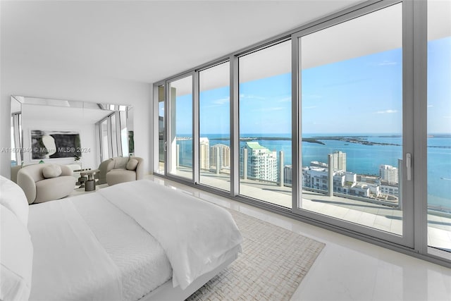 bedroom with a water view, access to outside, and multiple windows